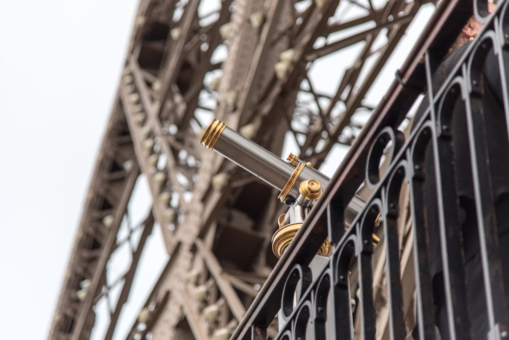 shallow focus photography of silver and gold telescope