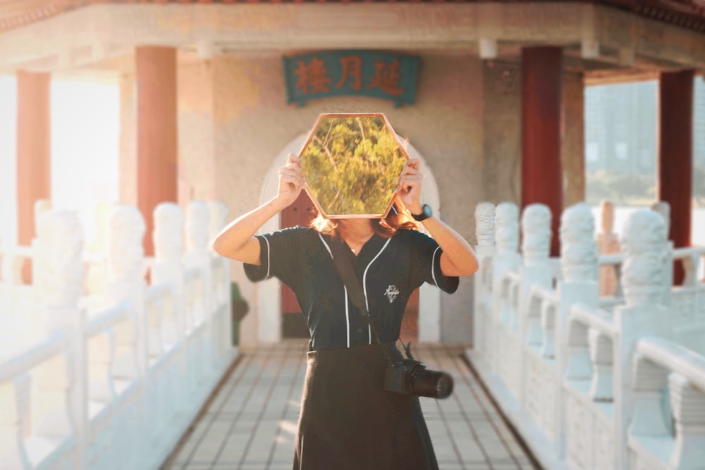 woman holding yellow poster