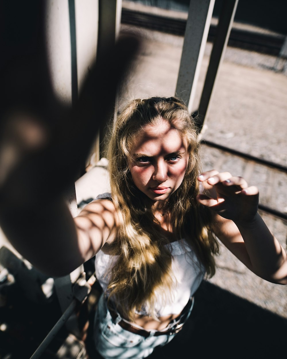 selective focus of woman standing on shed with shadow piercing