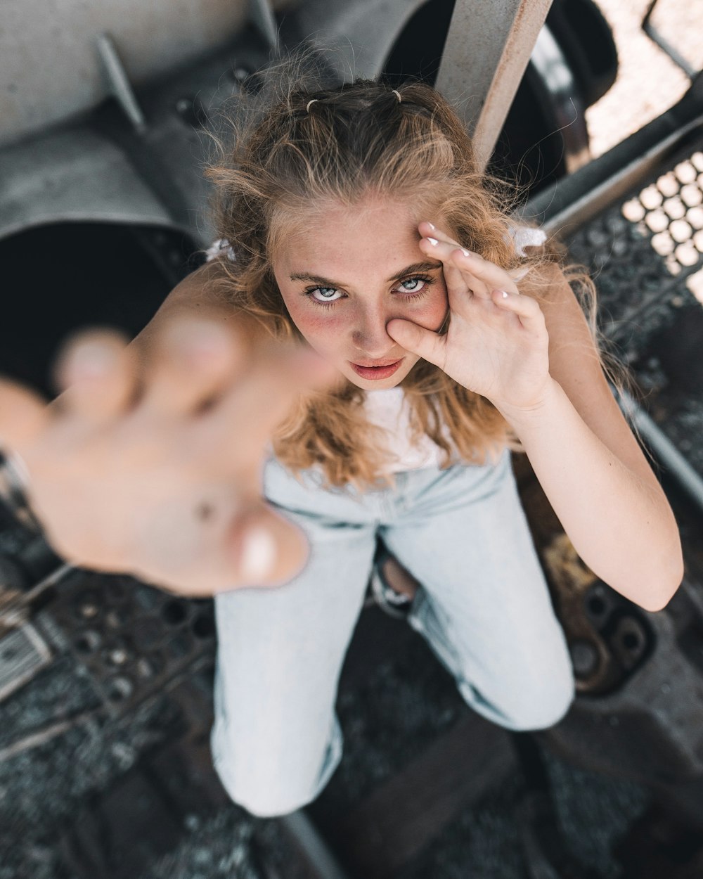 a woman holding her hand up to her face