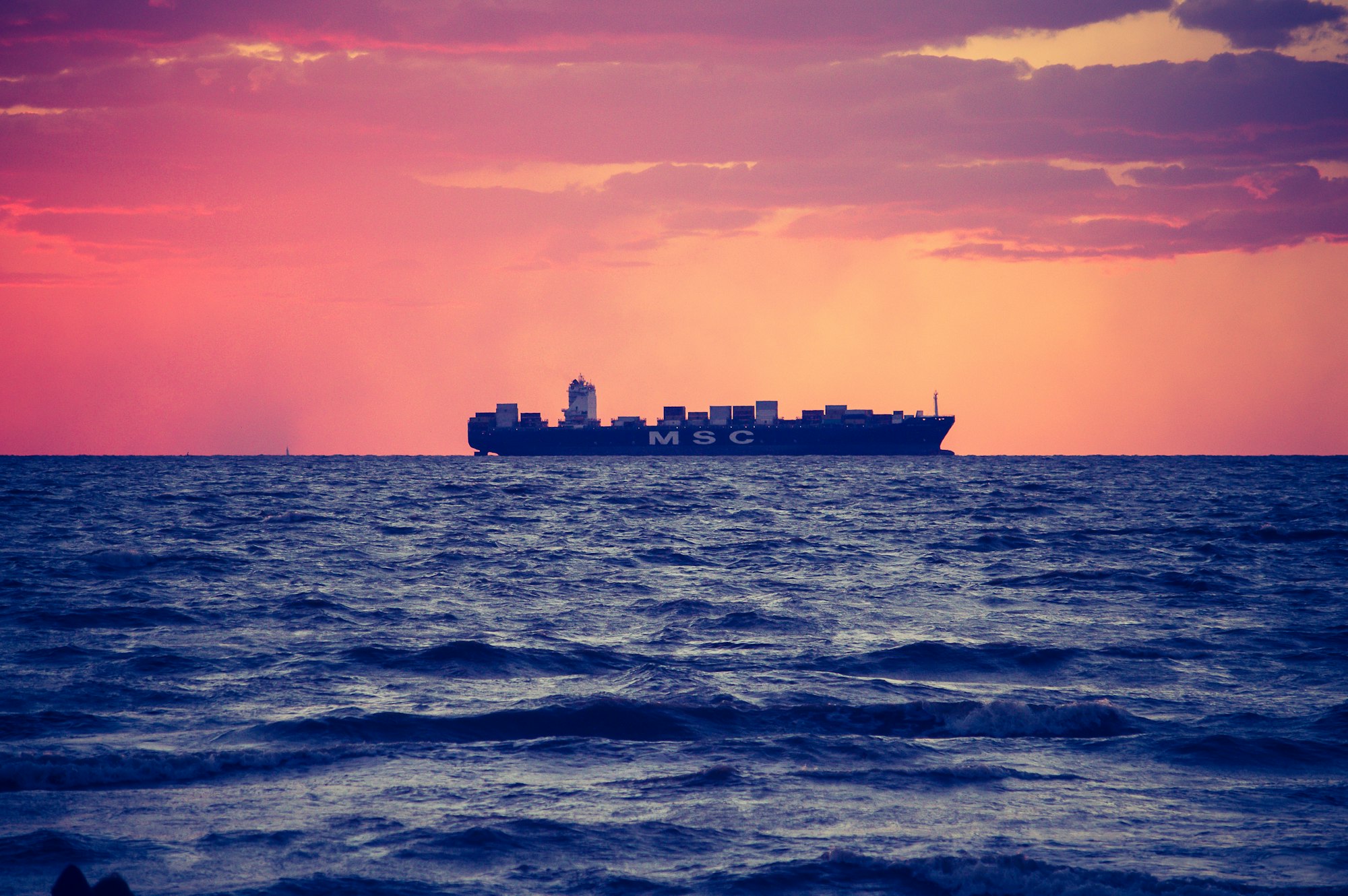 a large container ship on the horizon
