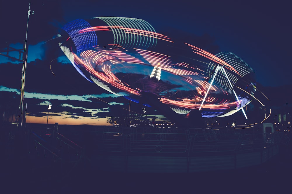 time lapse photography of amusement ride during night time