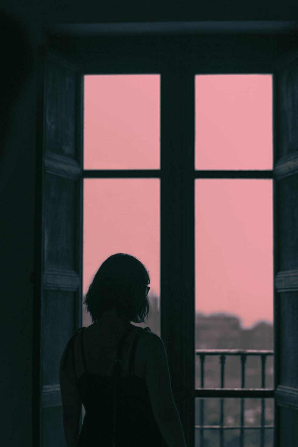 femme debout devant la fenêtre