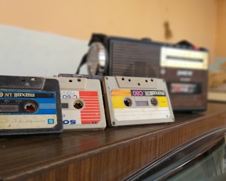 cassette tapes on brown wooden surface