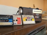 A vintage radio surrounded by colorful cassette tapes.