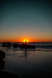Fisherman hoping for the last catch of the day at sunset