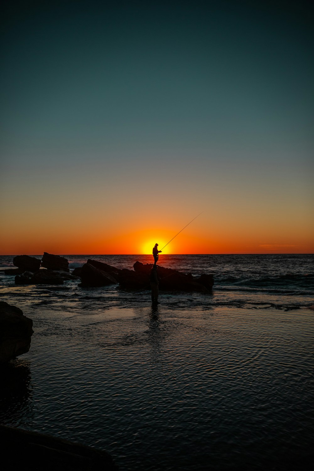 Silhouette of man holding fishing rod photo – Free Fishing Image