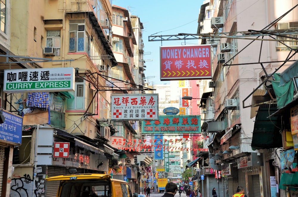 assorted store signages hanging on street