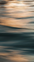 a blurry photo of a surfboard in the water