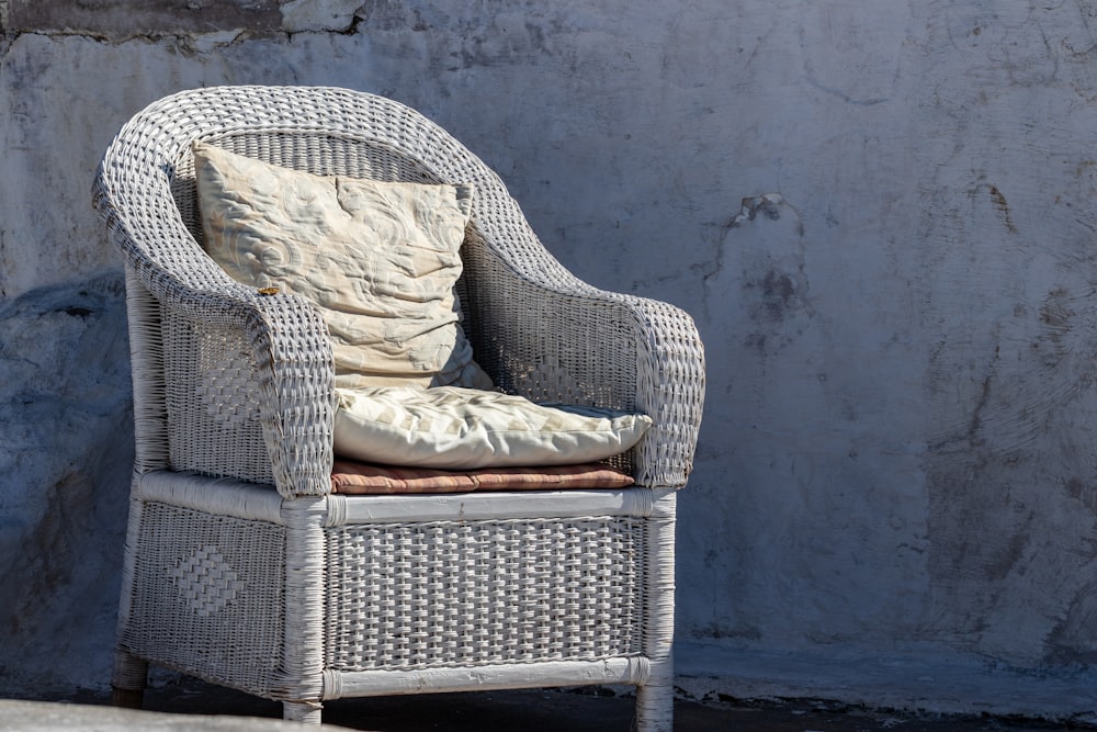 gray wicker armchair with gray cushion pads