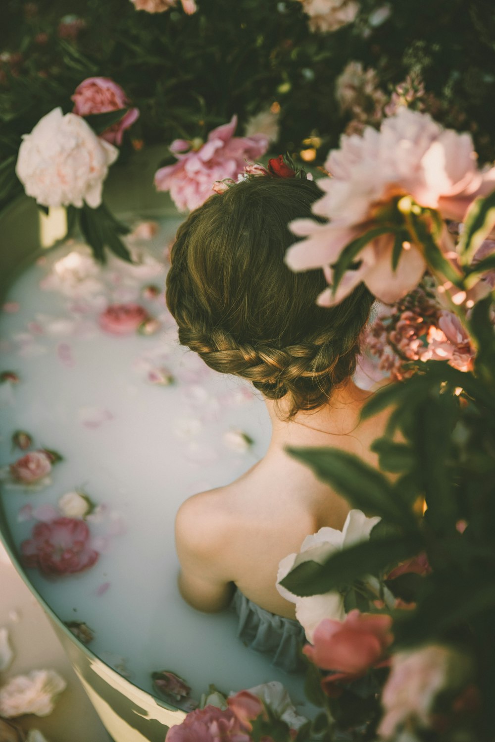 woman beside pink and purple flowers