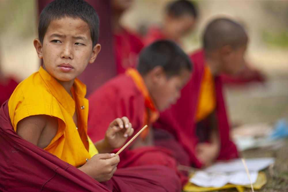 selective focus photography of boy sitting in round