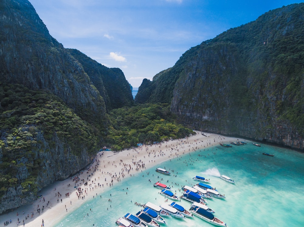 bird's eye view photography of boats in front of people gathered on seashore