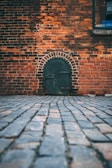 black metal door on brick wall