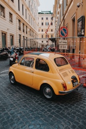 orange beetle-style car parked near building