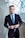man wearing black and teal dress suit standing near gray wall