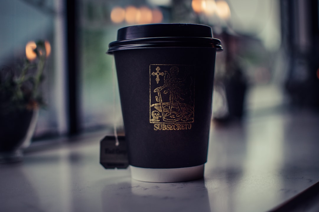 shallow focus photography of black coffee cup