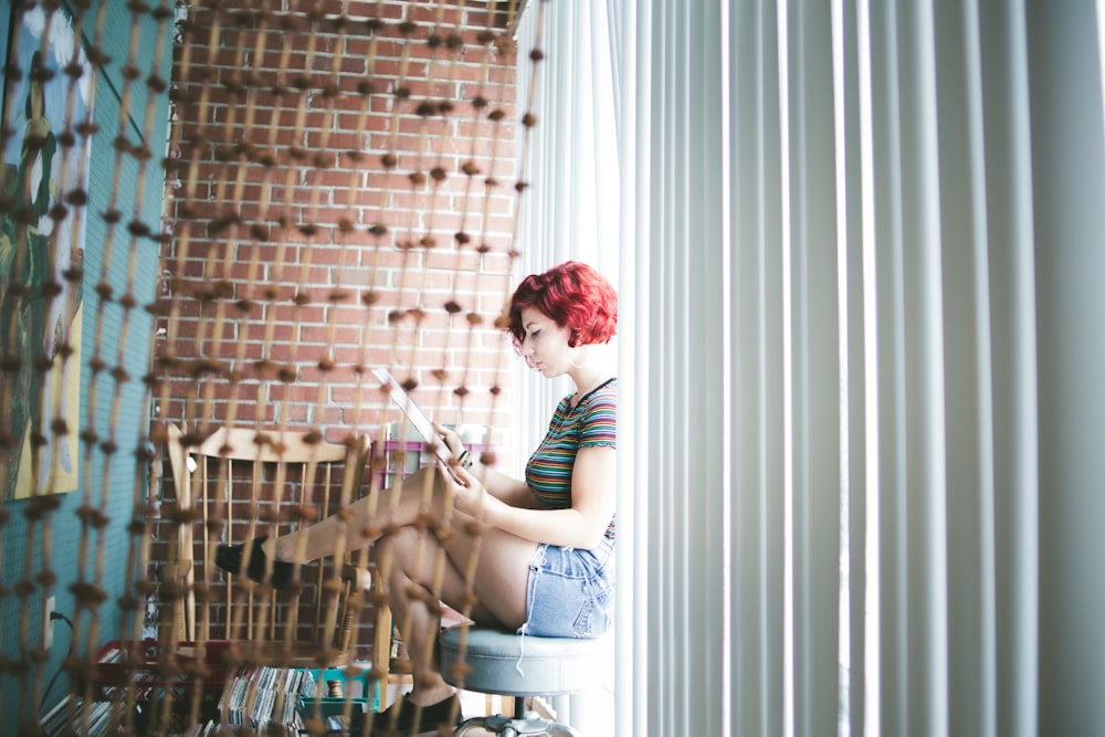 woman sitting on gray floor