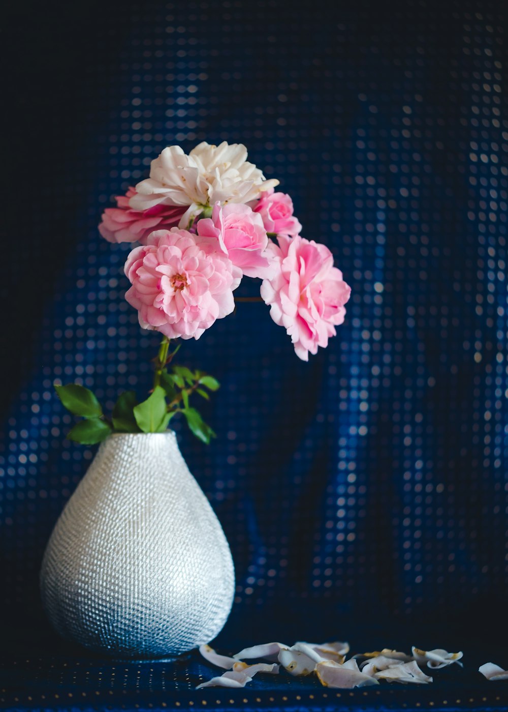 white and pink flower arrangement on white vase