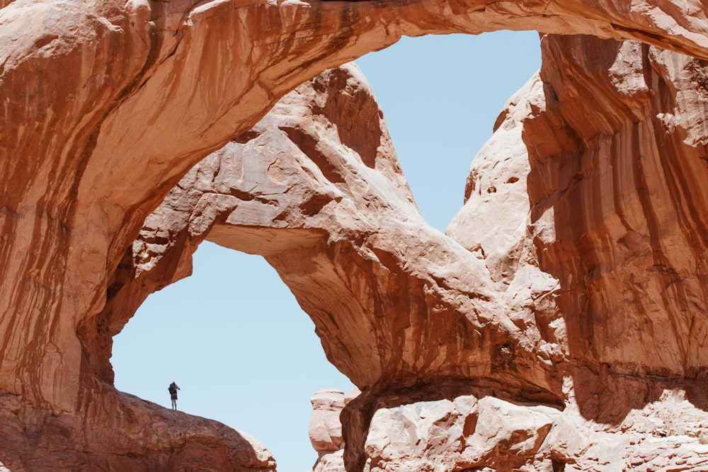 man standing on brown mountains during daytime