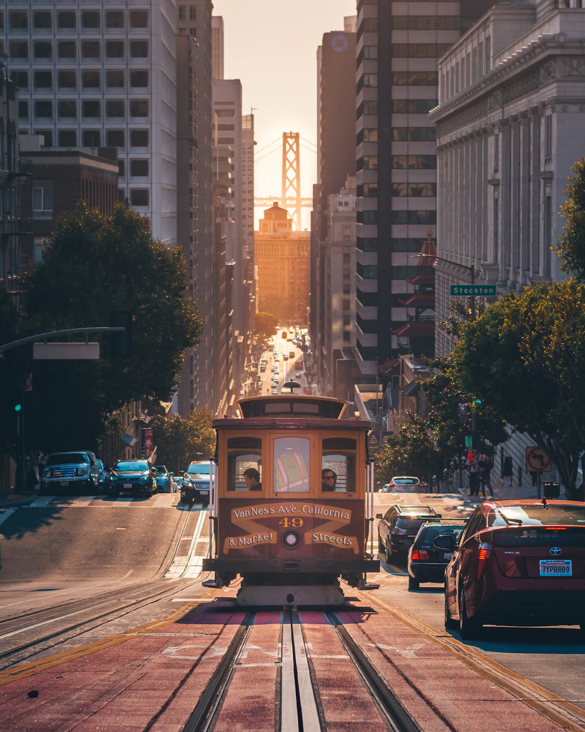 A cable car climbing a San Francisco street at sunrise