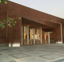 Architectural blueprint overlay on a modern building facade with warm brick accents.