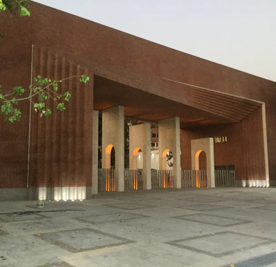 Architectural blueprint overlay on a modern building facade with warm brick accents.