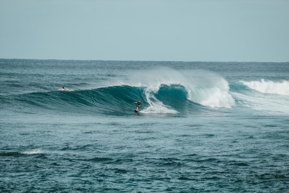 person surfboarding on waves