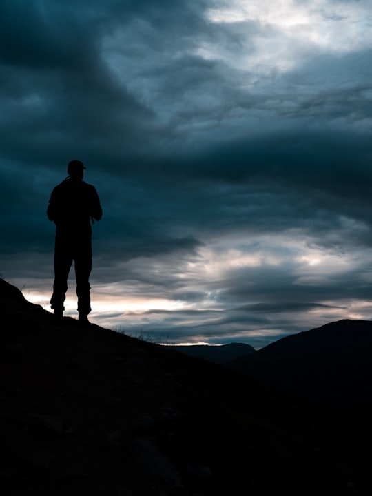 silhouette of person standing in Galdhøpiggen Norway