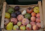 Rustic wooden crate filled with colorful dried fruit packages ready to ship.
