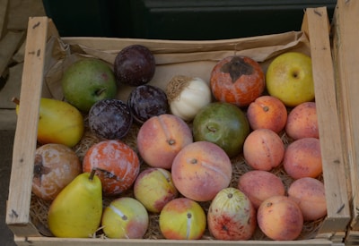 Rustic wooden crate filled with colorful dried fruit packages ready to ship.
