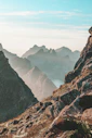 closeup photo of rocky mountain under blue and white sky