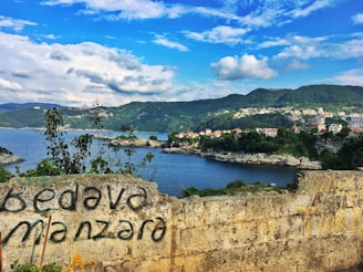 A scenic view of the Karadeniz coastline with a community gathering in the foreground.