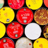Close-up of ecooil collect branded barrels filled with collected used oil ready for transport.