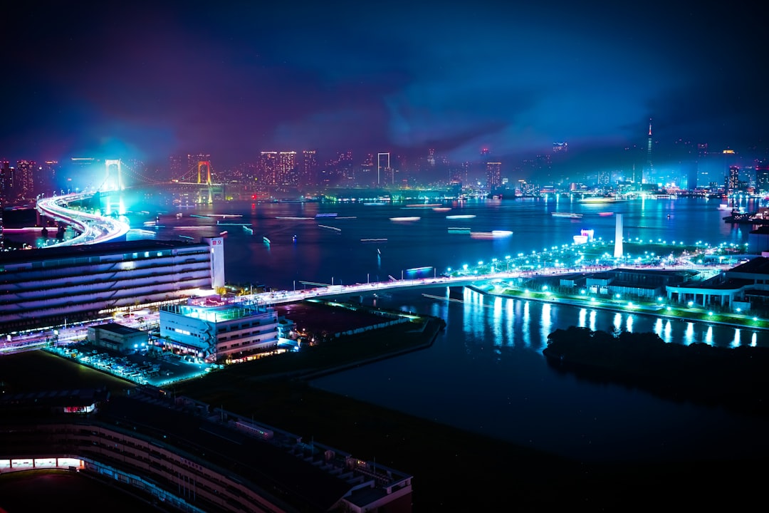 cityscape photo of buildings, I took this shot just after the fireworks had finished over Tokyo Bay. The smoke was cloud