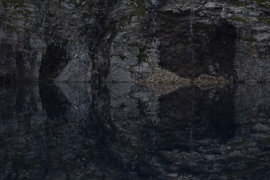 brown and gray cave with body of water in Formazza Italy