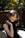woman in black sleeveless top standing beside fence
