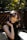 woman in black sleeveless top standing beside fence