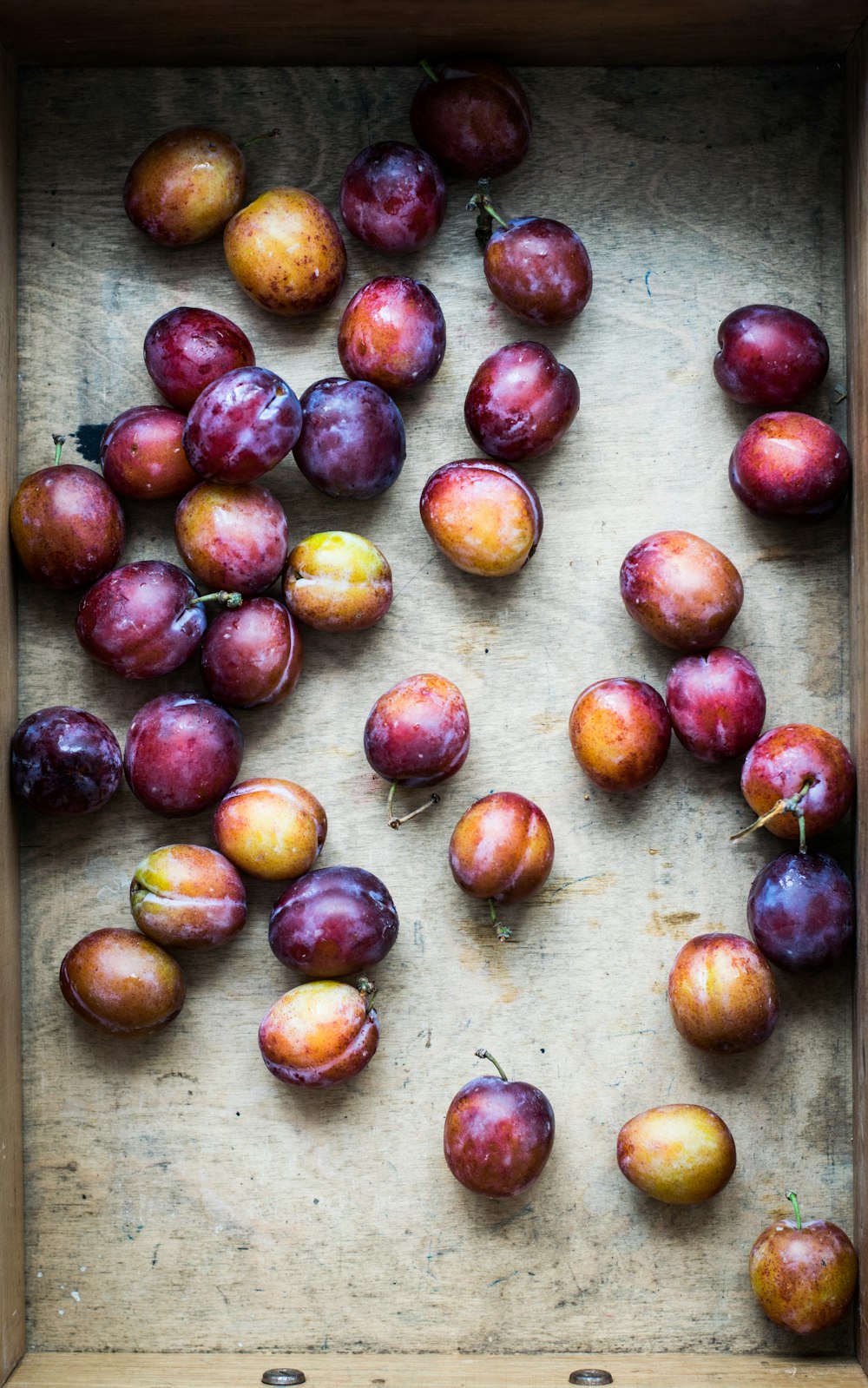 bunch of Spanish plum on brown surface