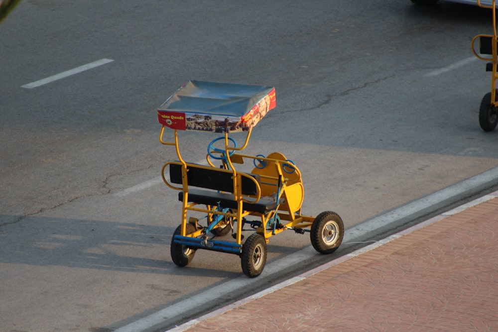 yellow pedal cart on road