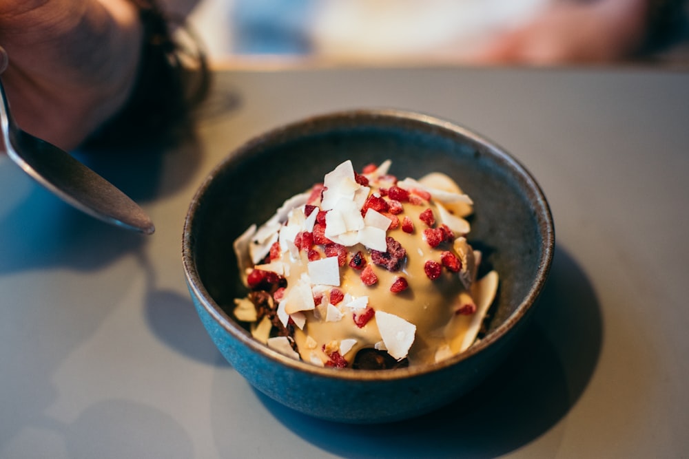 ice cream with cereals on black ceramic bowl