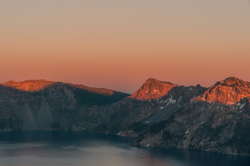 body of water surrounded mountain