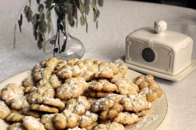 Elegant arranged maamoul cookies dusted with powdered sugar on a minimalist ceramic dish.