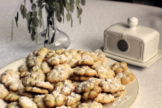 Elegant arranged maamoul cookies dusted with powdered sugar on a minimalist ceramic dish.