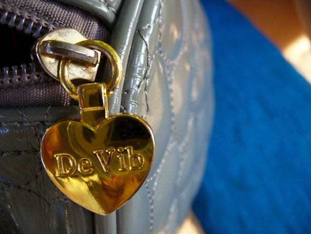 A close-up of a vibrant red vivatote handbag highlighting its scratch-resistant fabric and sturdy hardware.