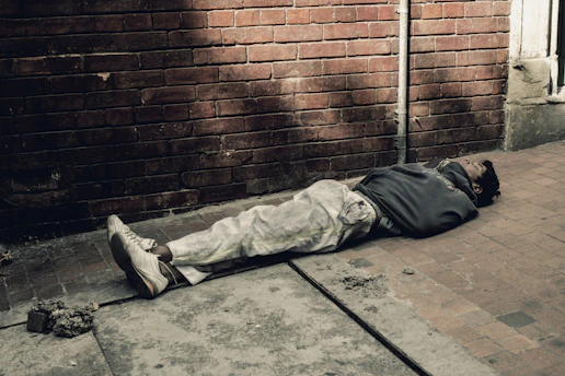 Person practicing close-quarter combat techniques in an urban alleyway.