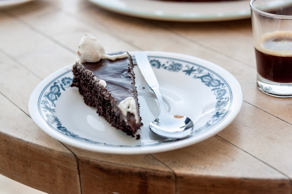 sliced chocolate cake served on white saucer