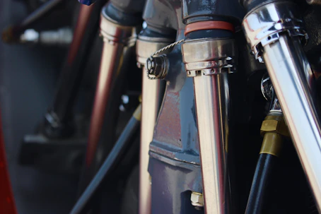 Close-up of a horizontal slurry pump with metallic finish under bright workshop lights.
