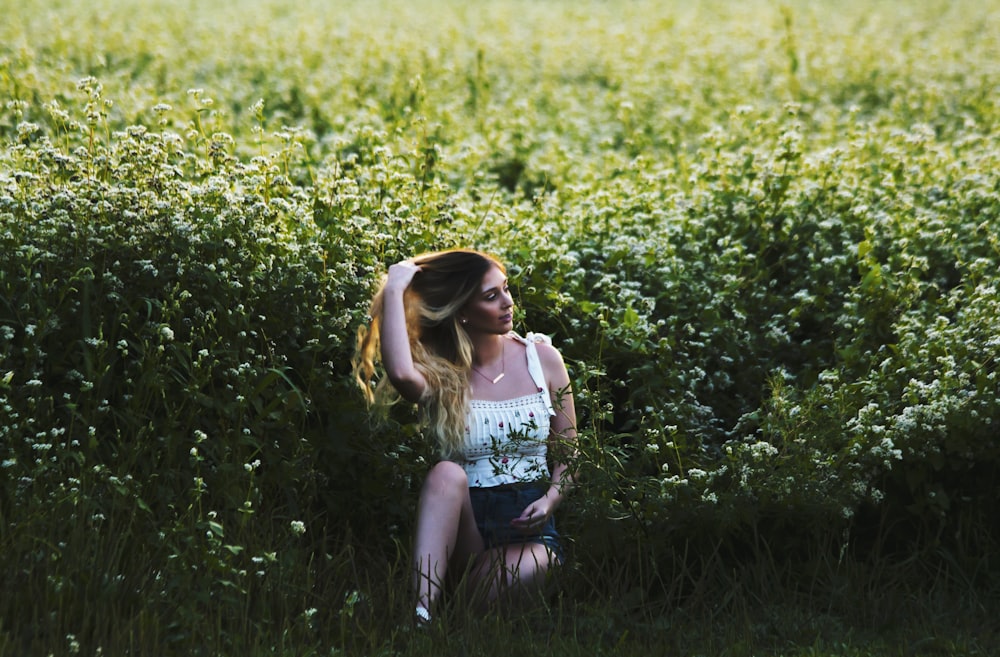 woman sitting at flower meadow