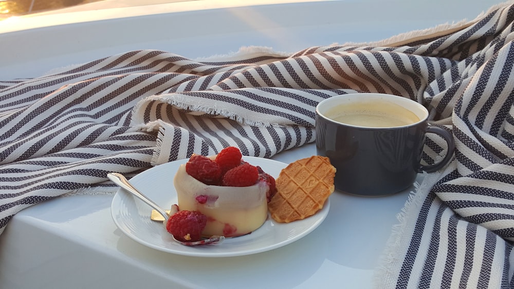 strawberries and black ceramic mug with coffee